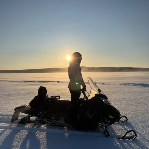 Snowmobiling_frozen_lake_sunset